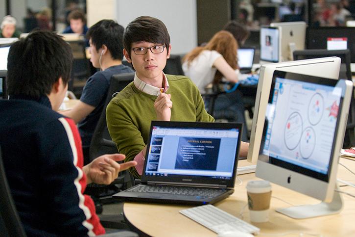 Two colleagues working at a computer