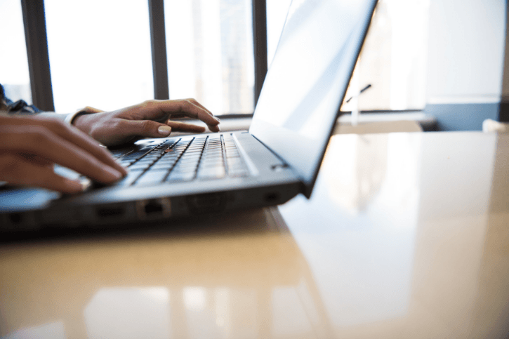hands typing on laptop