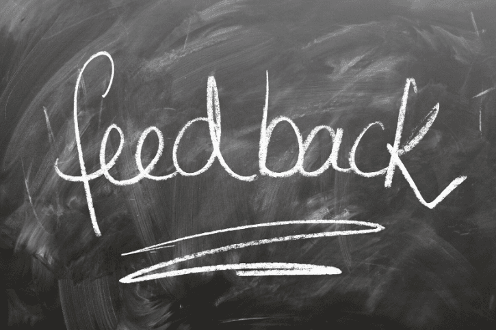 "feedback" written in cursive on a chalkboard
