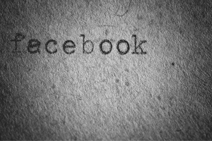 "facebook" typed on a grainy sheet of shadowed paper