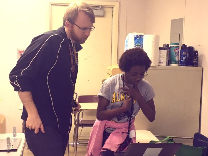 Two people looking at laptop