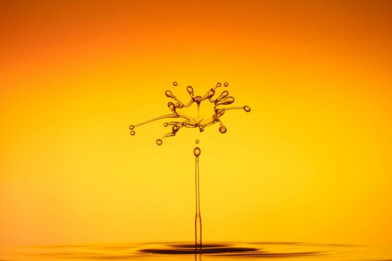 photo of water dripping, upside-down, on an orange-fading-to-yellow background