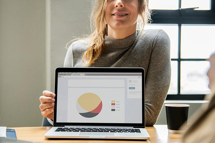 Woman showing chart on laptop
