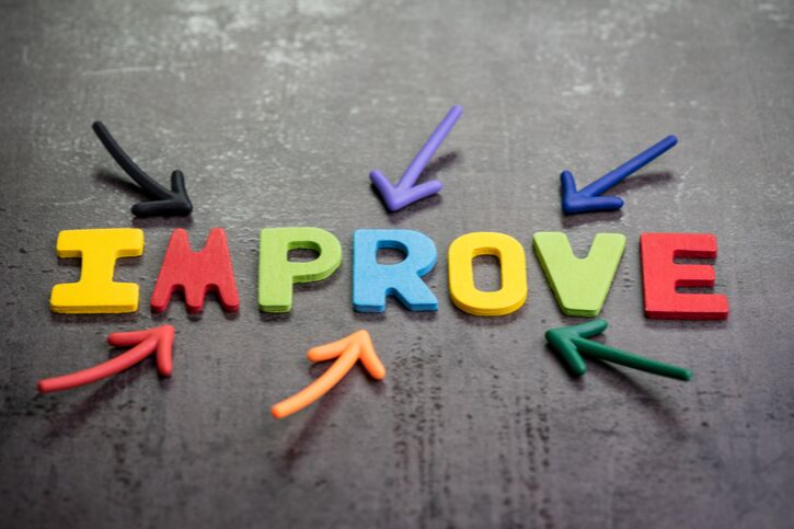 The word Improve in colorful letters surrounded by colorful arrows pointing at it